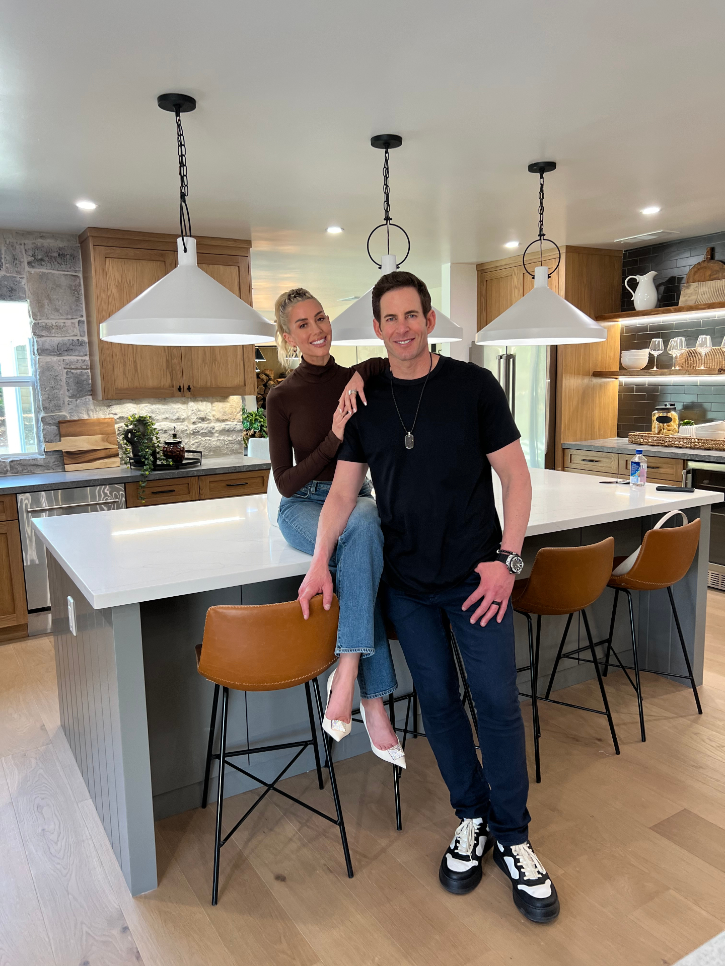 Couple posing in a finished kitchen during a home-focused portrait session